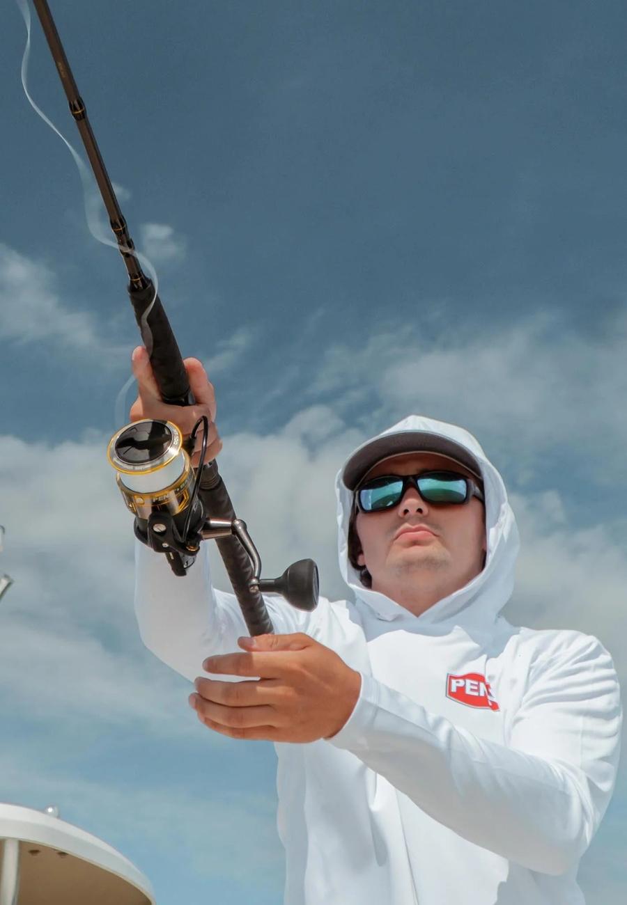 Angler fighting a fish with PENN gear